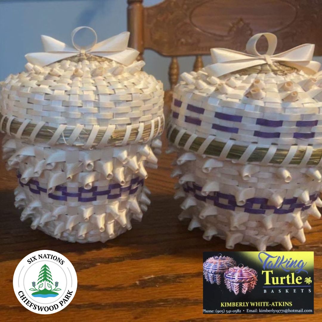 Two traditional baskets with natural materials and designs woven in purple.